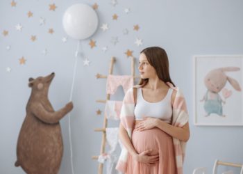 beautiful pregnant woman holding her belly