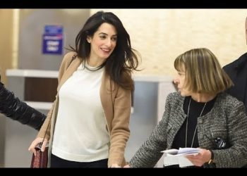 WATCH !!! Pregnant Amal Clooney Looks Truly Radiant in Simple White Jumper at JFK Airport – VIDEO