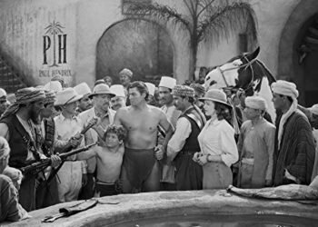 Johnny Weissmuller Being Seized by Armed Men in a Classic Movie Scene Photo Print (30 x 24)